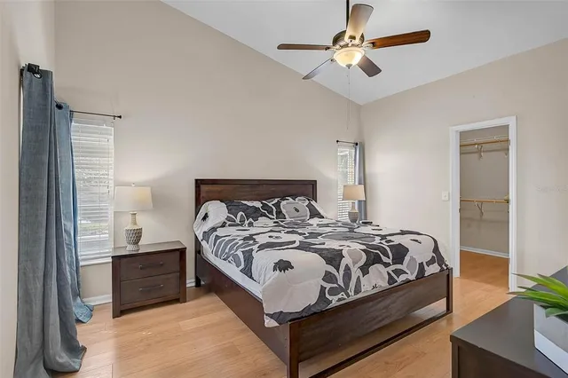 a bedroom with a bed and a chandelier