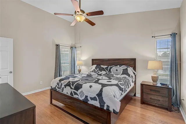 a bedroom with a bed and wooden floor