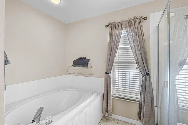 a bathroom with a bathtub and shower