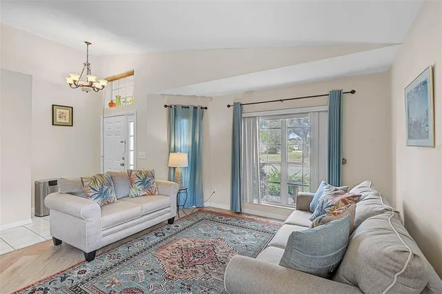 a living room with furniture and a chandelier