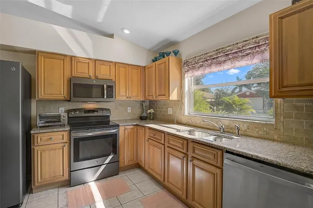 a kitchen with a sink stove and microwave
