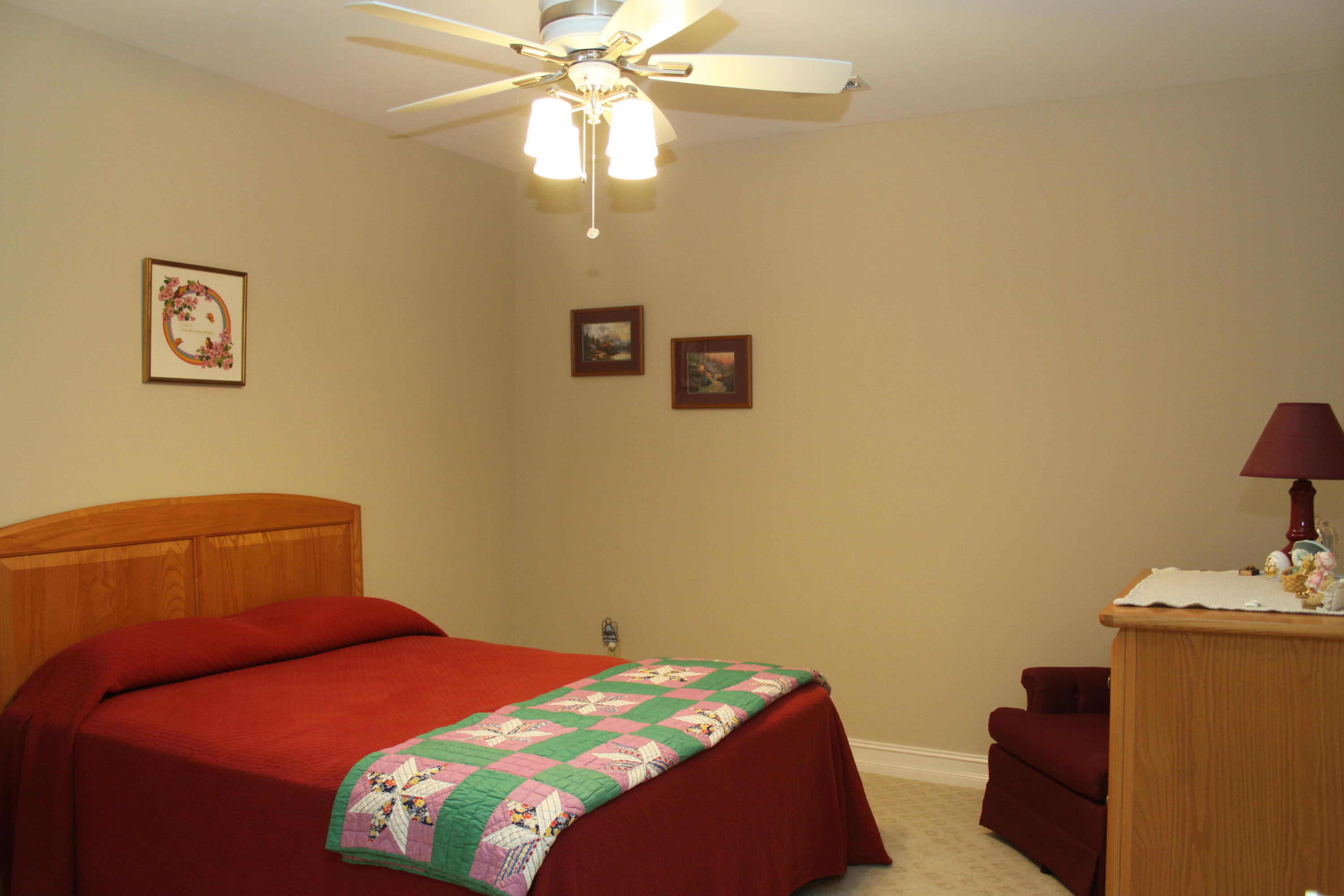 159 Calypso Road Moneta, VA 24121 - Photo 44 of 72 a bedroom with a bed and a chandelier