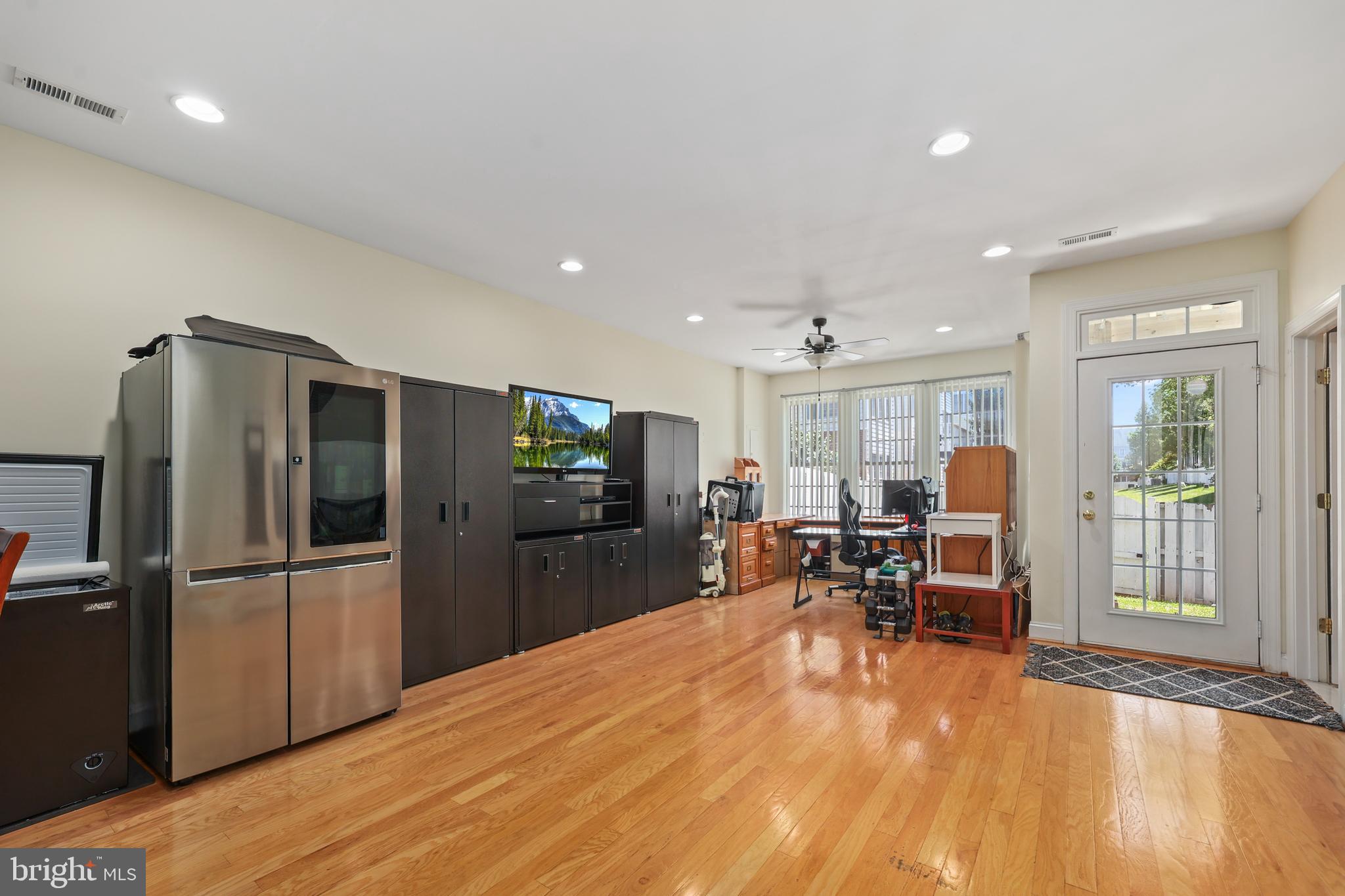 6806 Witton Circle Gainesville, VA 20155 - Photo 28 of 47 a kitchen with stainless steel appliances granite countertop a refrigerator oven a sink dishwasher a dining table and chairs with wooden floor