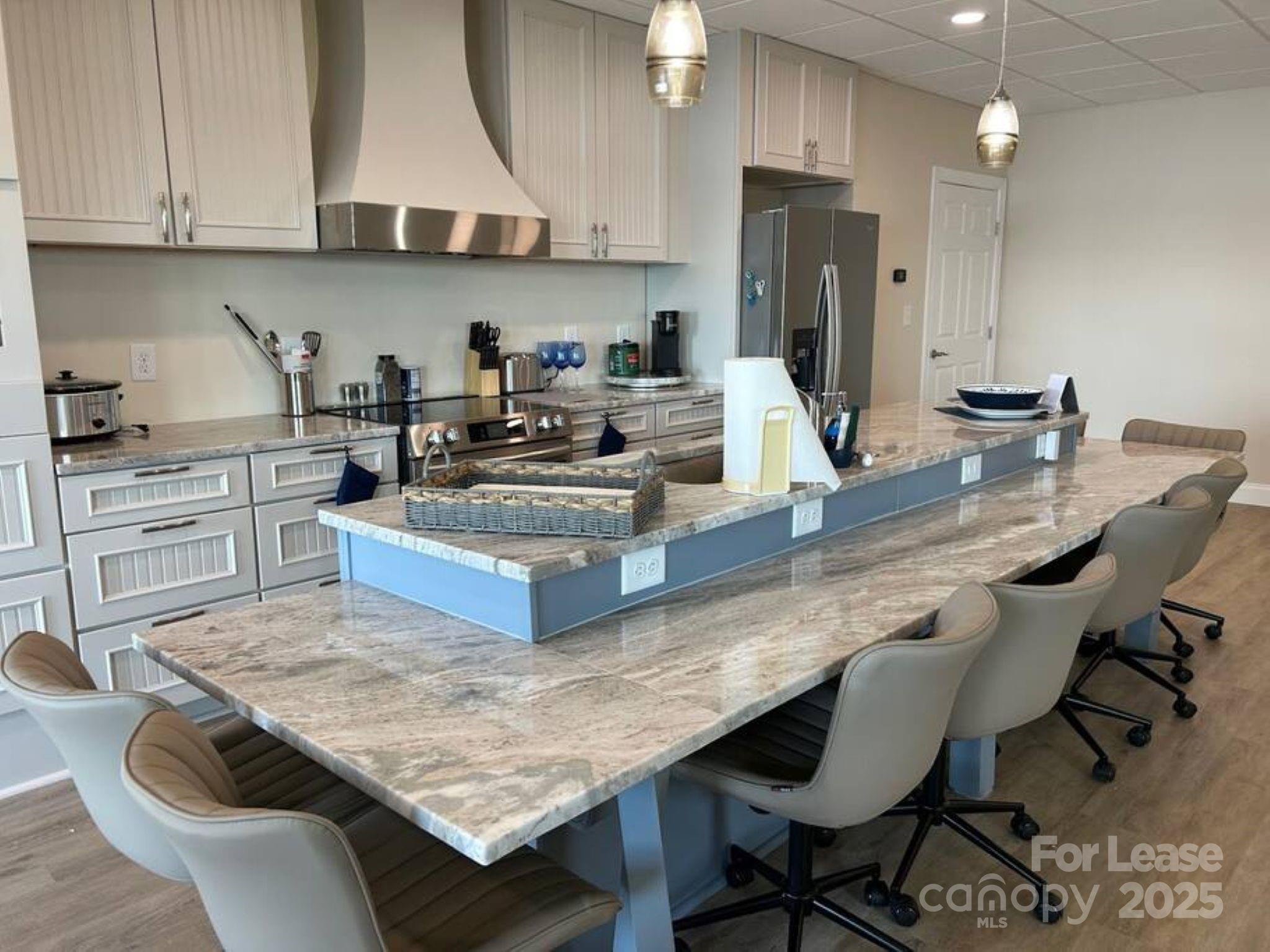 4897 Kiser Island Road, Unit B Terrell, NC 28682 - Photo 2 of 18 a kitchen with kitchen island granite countertop a table chairs sink and cabinets