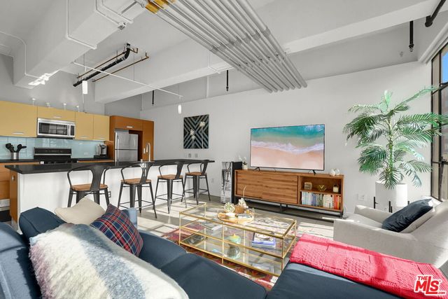 a living room with furniture fireplace and flat screen tv