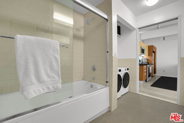 a bathroom with a bathtub and a shower