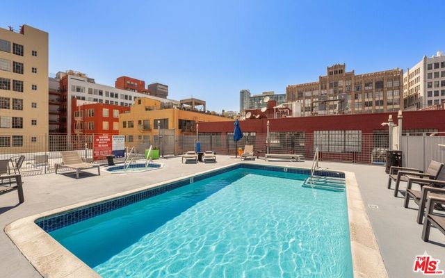 a view of swimming pool with outdoor seating and city view