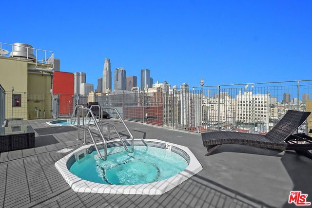 a view of a swimming pool with outdoor seating and a buildings