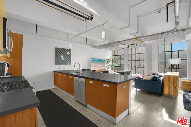 a kitchen with stainless steel appliances granite countertop a stove and a refrigerator