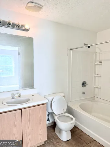 a bathroom with a sink toilet a shower and bathtub
