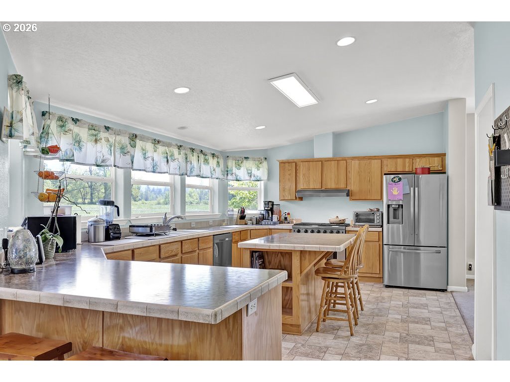 38277 Wheeler Road Dexter, OR 97431 - Photo 12 of 47 a kitchen with a table chairs refrigerator and cabinets