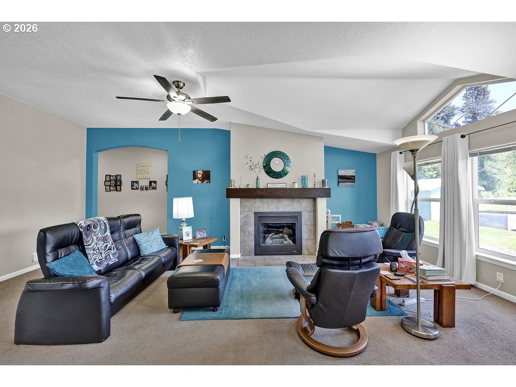 38277 Wheeler Road Dexter, OR 97431 - Photo 18 of 47 a living room with furniture a fireplace and a large window