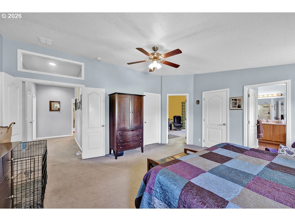 38277 Wheeler Road Dexter, OR 97431 - Photo 20 of 47 a bedroom with a bed and a chandelier