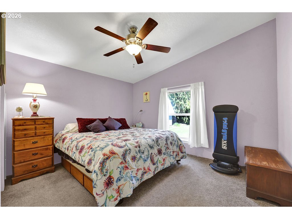 38277 Wheeler Road Dexter, OR 97431 - Photo 26 of 47 a bedroom with a bed and a chandelier