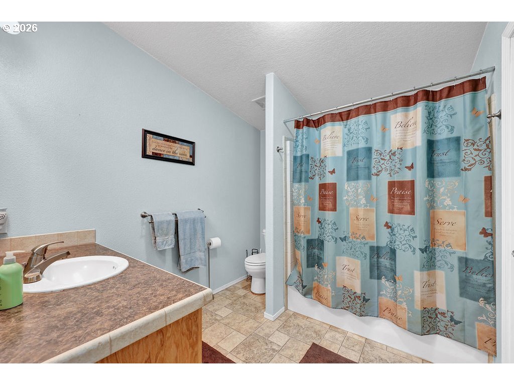 38277 Wheeler Road Dexter, OR 97431 - Photo 28 of 47 a bathroom with a granite countertop sink a mirror and a shower
