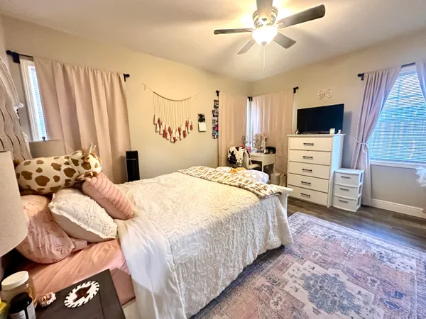 a bedroom with a bed and a television