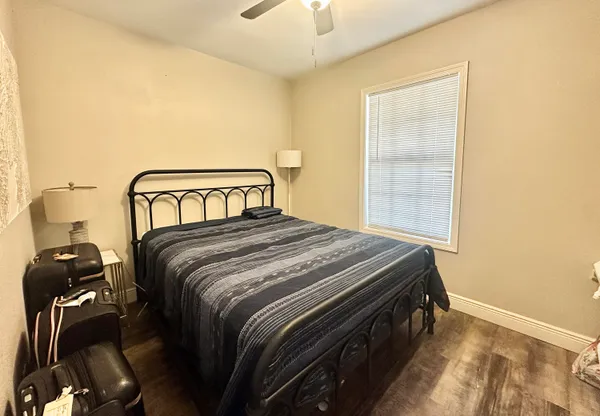 a bedroom with a bed and a chandelier