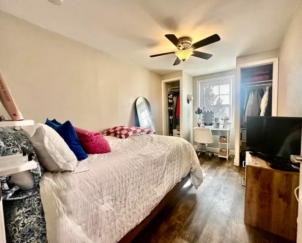 a bedroom with a bed and a flat screen tv