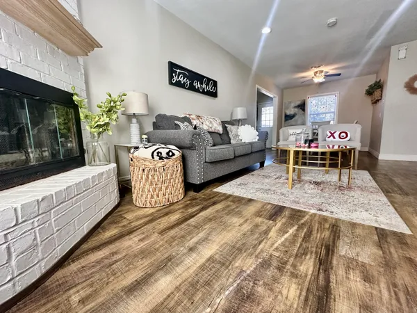 a living room with furniture and a fireplace