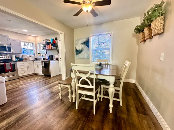 a view of a dining room with furniture and wooden floor