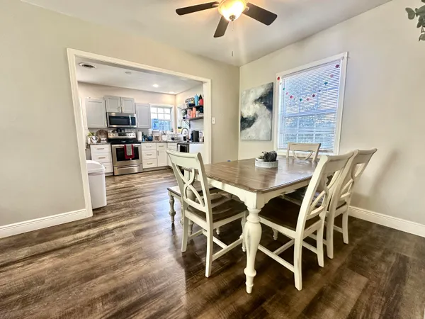 a view of a dining room with furniture wooden floor and chandelier