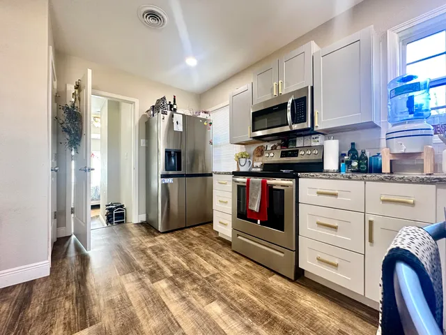 a kitchen with stainless steel appliances a refrigerator stove and microwave