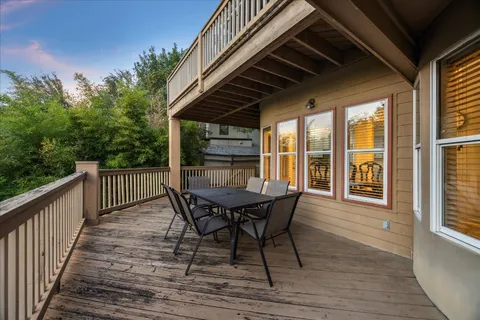 a view of a wooden chairs on the roof deck