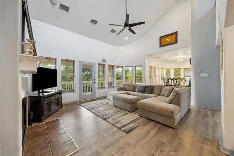 a living room with furniture a flat screen tv and a large window