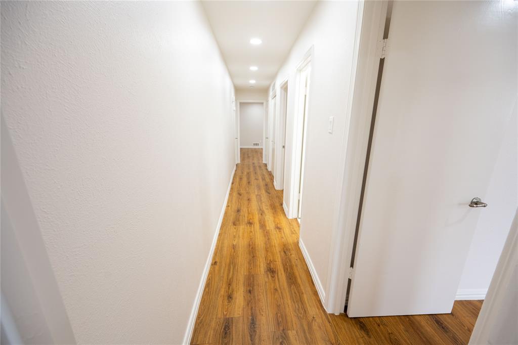 6105 Rincon Way Dallas, TX 75214 - Photo 11 of 11 a view of a hallway with wooden floor and entryway