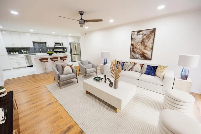 a living room with furniture and kitchen view