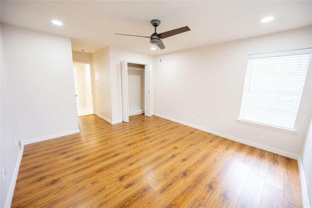 6105 Rincon Way Dallas, TX 75214 - Photo 9 of 11 a view of empty room with wooden floor and fan