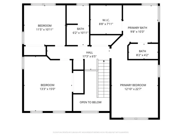 a large kitchen with stainless steel appliances kitchen island granite countertop a large stove a refrigerator a sink a dining table and chairs with wooden floor