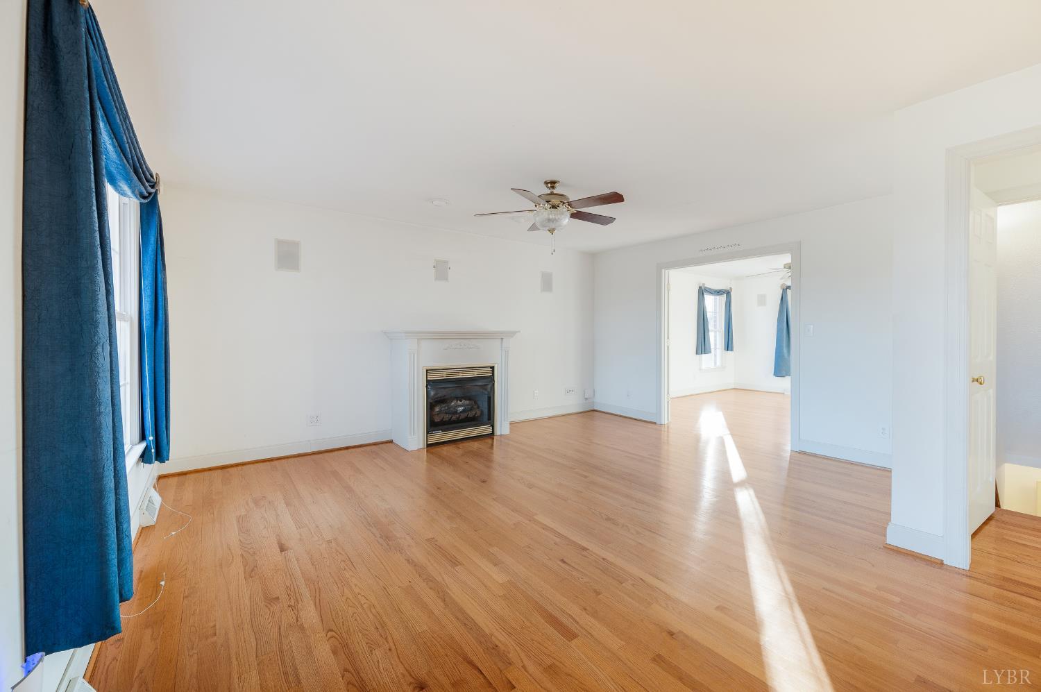 1083 High Grove Lane Forest, VA 24551 - Photo 17 of 75 a view of an empty room with wooden floor and a fireplace