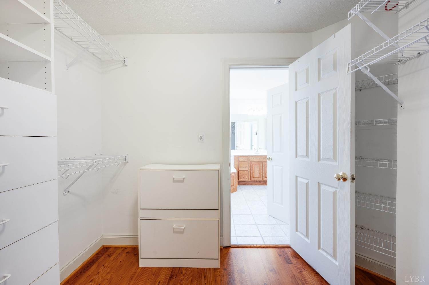 1083 High Grove Lane Forest, VA 24551 - Photo 41 of 75 a view of walk in closet with wooden floor
