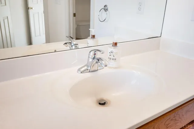 a bathroom with a toilet and mirror