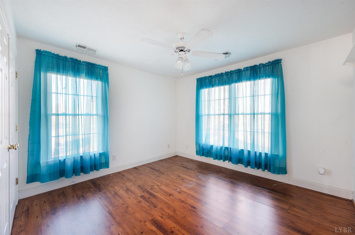 1083 High Grove Lane Forest, VA 24551 - Photo 56 of 75 an empty room with wooden floor and windows