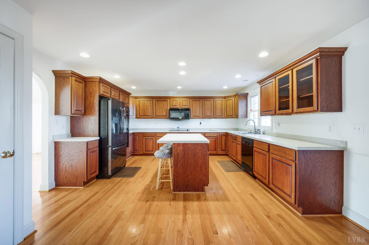 1083 High Grove Lane Forest, VA 24551 - Photo 61 of 75 a large kitchen with stainless steel appliances kitchen island granite countertop a large stove a refrigerator a sink a dining table and chairs with wooden floor