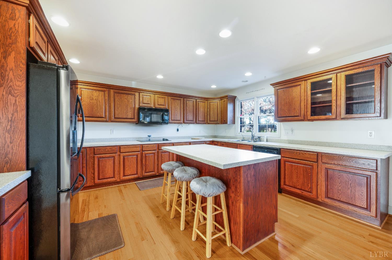 1083 High Grove Lane Forest, VA 24551 - Photo 68 of 75 a kitchen with stainless steel appliances granite countertop wooden cabinets a sink and dishwasher a stove with wooden floor
