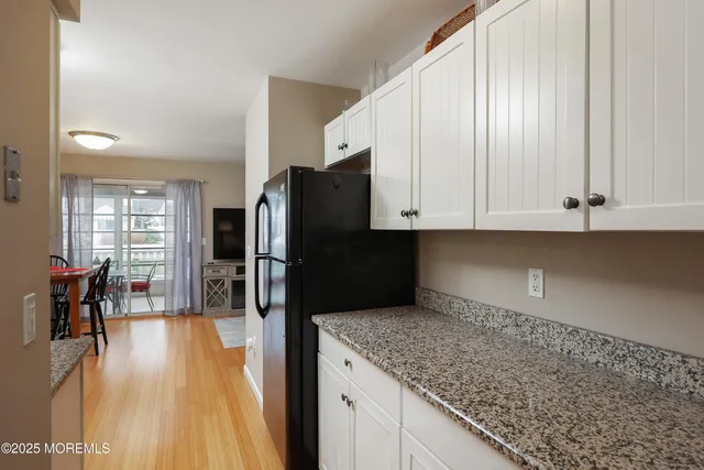 a kitchen with stainless steel appliances granite countertop a refrigerator and microwave