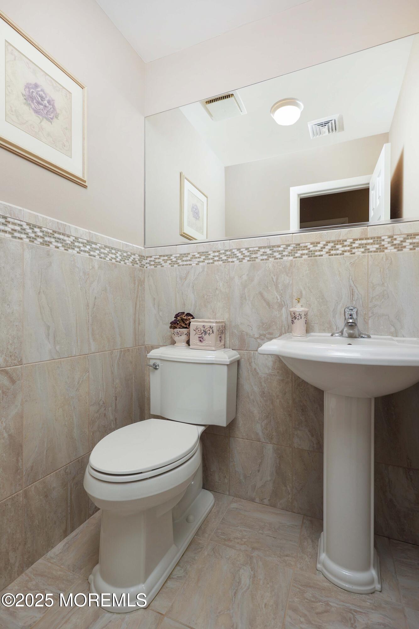41 Longpoint Drive Brick, NJ 08723 - Photo 14 of 22 a bathroom with a toilet sink and mirror