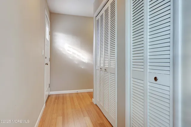 a view of a hallway with wooden floor
