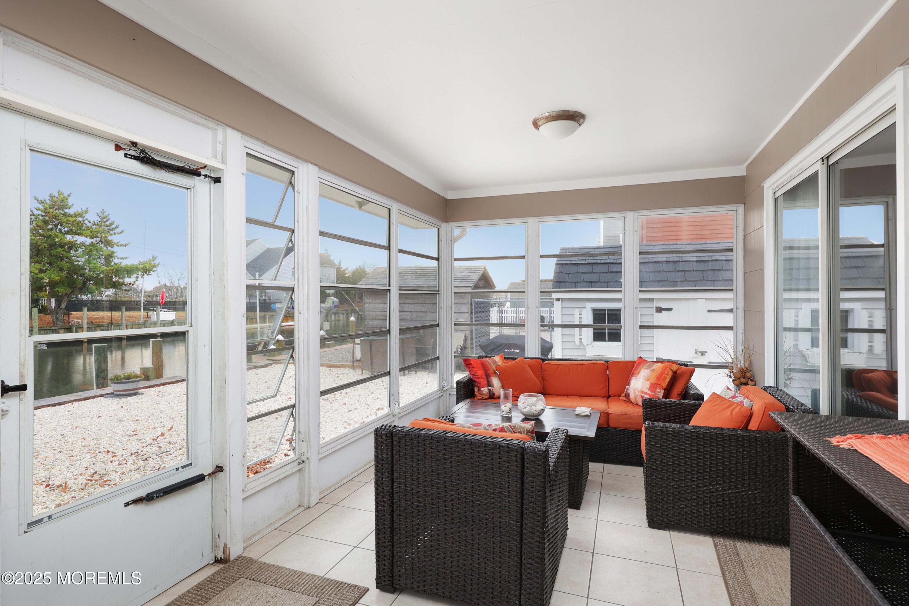 41 Longpoint Drive Brick, NJ 08723 - Photo 9 of 22 a living room with furniture and a floor to ceiling window