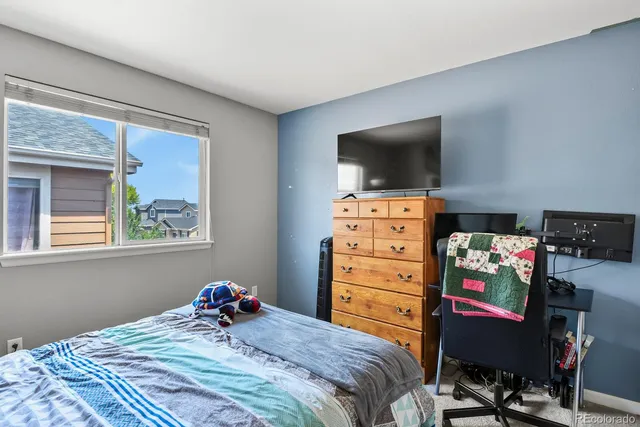 a bedroom with a bed and a painting on the wall