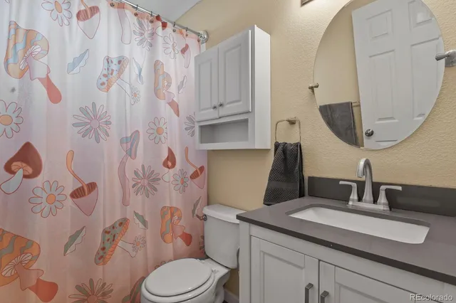 a living room with furniture a flat screen tv and a window