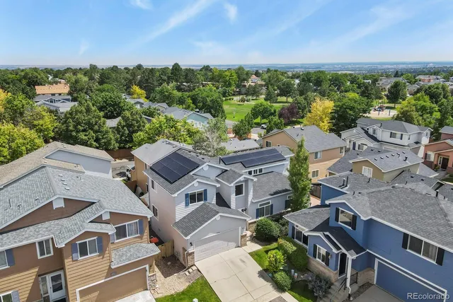 an aerial view of multiple houses with yard