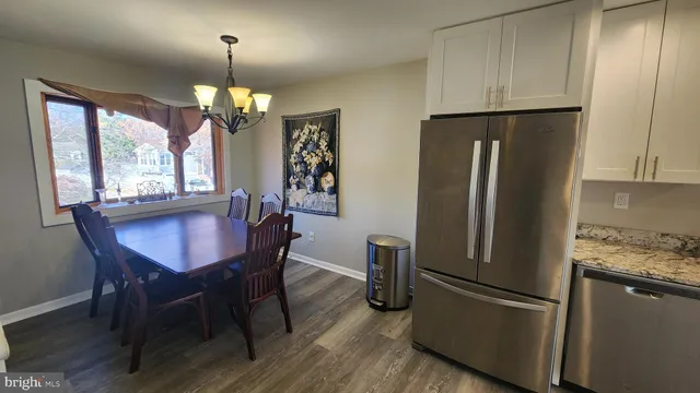 a kitchen with stainless steel appliances granite countertop a refrigerator a stove top oven a sink and dishwasher