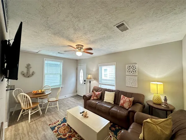 a living room with furniture a large window and a flat screen tv