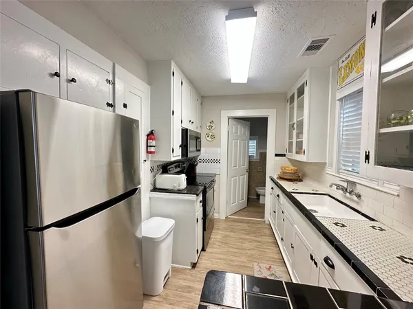 a kitchen with a refrigerator a sink and dishwasher