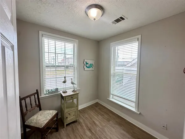 a view of a room with furniture and windows