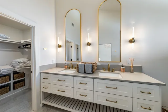 a bathroom with a double vanity sink and a mirror